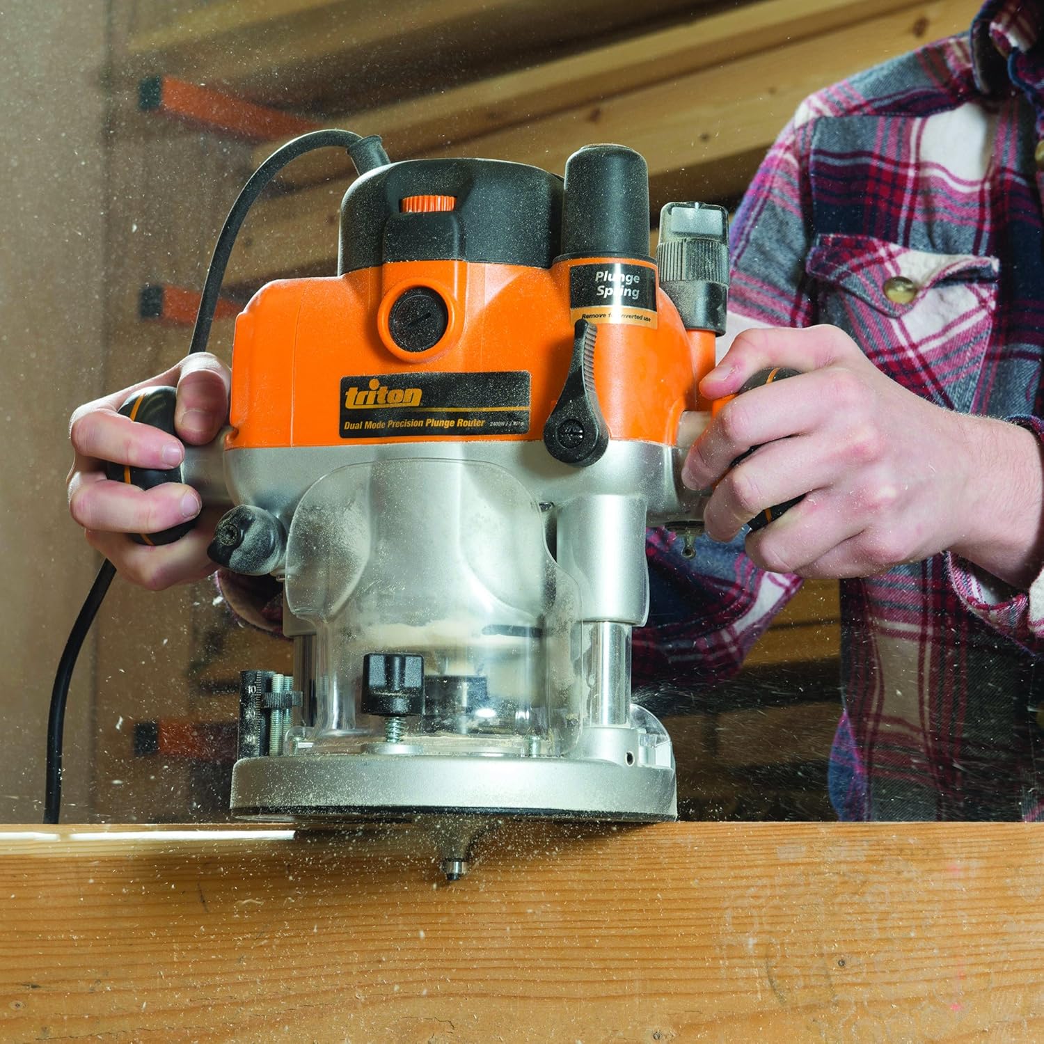 TRITON TRA001 compact trim router trimming an edge